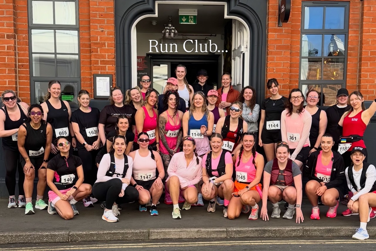 The Social Run Club group photo outside a venue